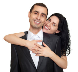 Couple embrace, studio portrait on white. Dressed in black suit.