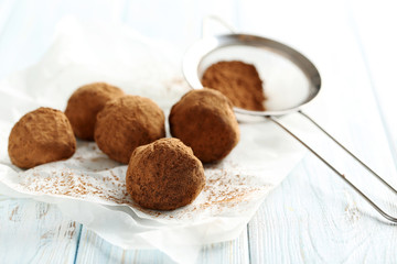 Sweet chocolate truffle on a blue wooden table