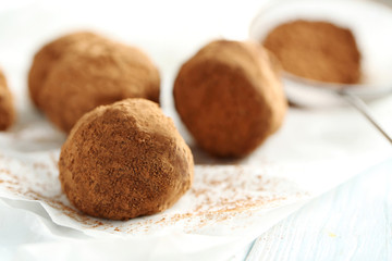 Sweet chocolate truffle on a blue wooden table