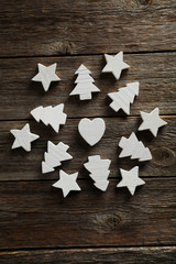 Decorative heart, stars and fir-tree on a grey wooden background