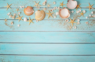 seashells and sand on wooden background