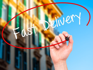 Man Hand writing  Fast Delivery with black marker 