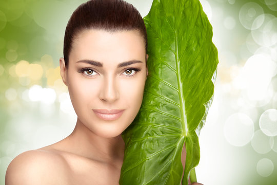 Beauty Spa Girl with a Green Fresh Leaf