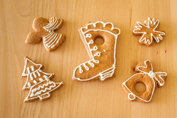 Christmas hand-decorated home gingerbreads on wooden table