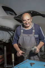 portrait of an elderly mechanic