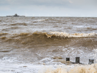 Waves over groynes in Herne Bay, Kent, UK