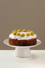 Homemade simnel cake with royal icing on white background for Ea