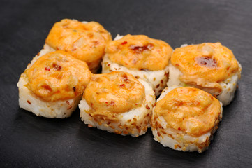 Baked hot cheese rolls on black plate