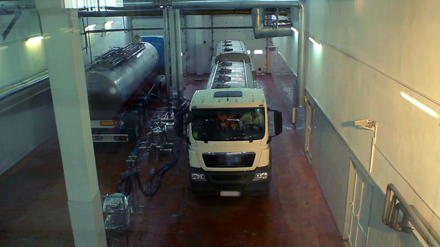 Milk truck in a dairy shop/Truck with tank at milk farm/Modern dairy factory/Food processing plant/Food Industry/Interior of a cheese factory/Food warehouse/Industrial equipment