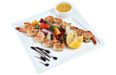Prawns grilled with vegetable on square ceramic serving dish iso