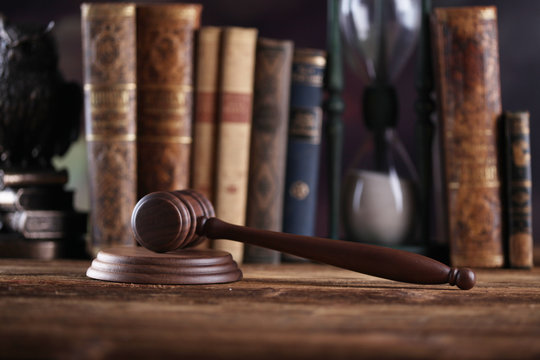 Law theme, mallet of judge, wooden gavel, books