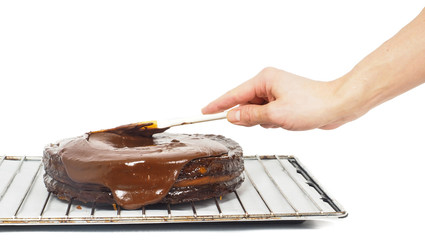 Pastry chef making final touches to a chocolate cake with