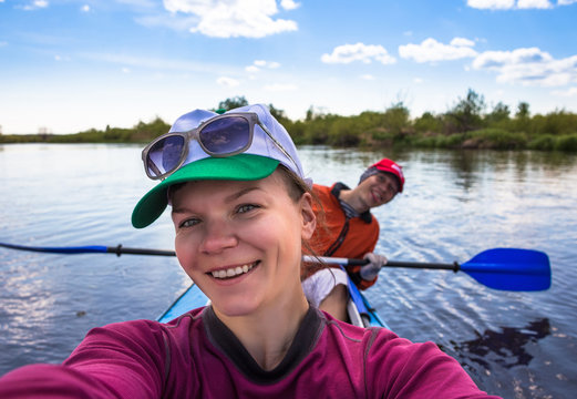 Young woman doing selfie on kayak in beautiful nature. Summer sunny day - Powered by Adobe