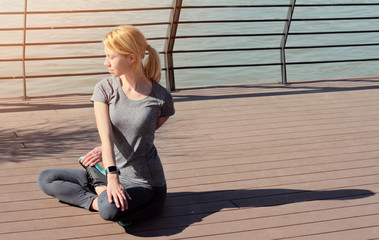 Woman  practicing yoga on wooden dock