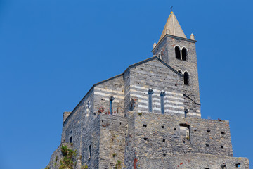 Fototapeta premium Church of San Pietro perched on its walls, seen from below