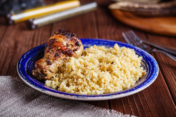 Homemade couscous with roasted chicken leg
