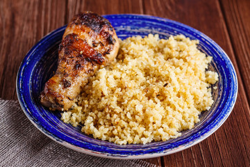 Homemade couscous with roasted chicken leg