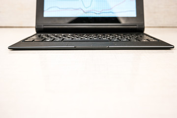 Fototapeta premium laptop with hands on wood