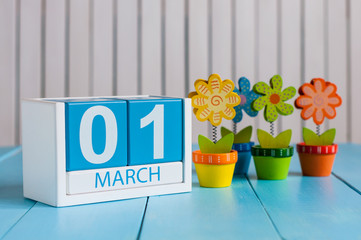 March 1st. Image of march 1 wooden color calendar with flower on white background.  First spring day, empty space for text