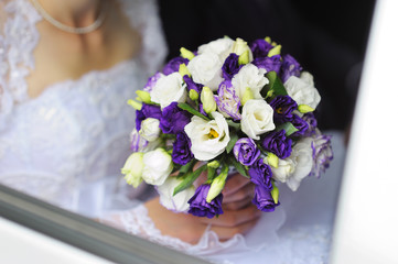 Bride holding wedding bouquet in her hand