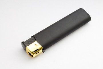 black lighter photographed on a gray background closeup
