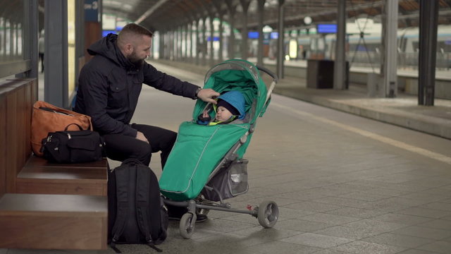 Upset Father with kid waiting on station 
