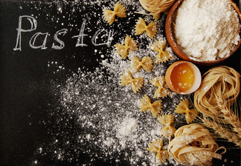 Uncooked pasta with flour on the table, selective focus