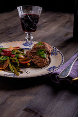 Beef Steak with some salad and a glass of wine
