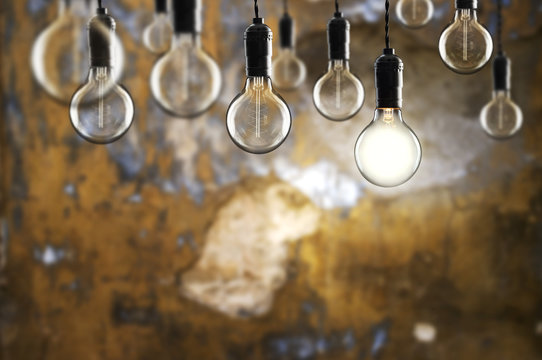 Idea and teamwork concept Vintage  bulbs on wall background