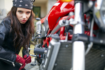 Fototapeta na wymiar woman repair a motorbike