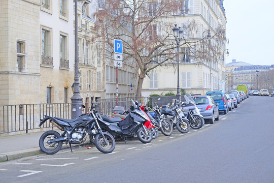 Paris, France, February 9, 2016: motorcycle parking on a street in a center of Paris, France. Motorcycles are very popular transport in Paris