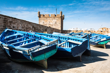 Fototapeta na wymiar Lots of blue fishing boats in the port of Essaouira, Morocco