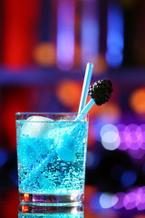 Glass of cocktail on bar background