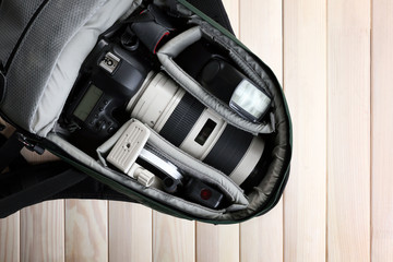 Fototapeta premium Photographer's equipment on a light wooden background