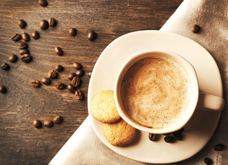 Cup of coffee on wooden table background