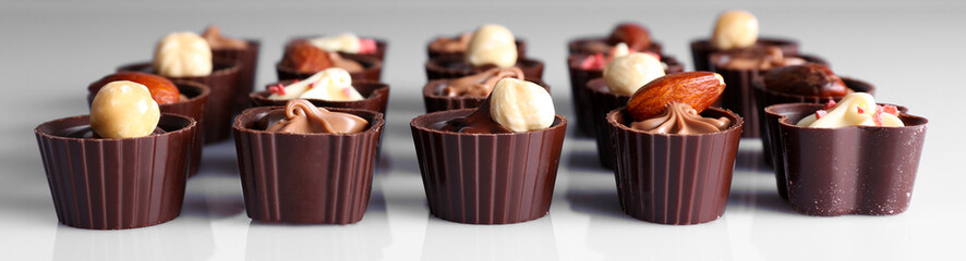 Delicious chocolate candies on white background