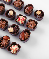 Delicious chocolate candies on white background