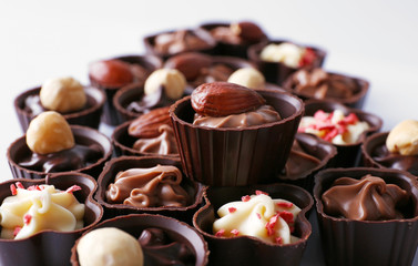 Obraz na płótnie Canvas Delicious chocolate candies on white background, close up