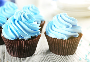 Blue cupcakes on wooden table