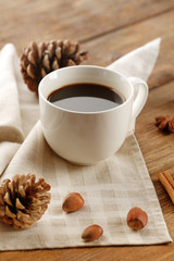 Cup of coffee on napkin on wooden background