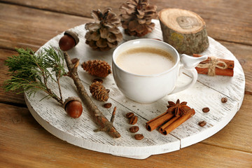 Obraz na płótnie Canvas Cup of coffee with sugar and cinnamon on white wooden mat