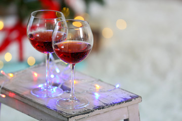 Two glasses of red wine on Christmas decoration background