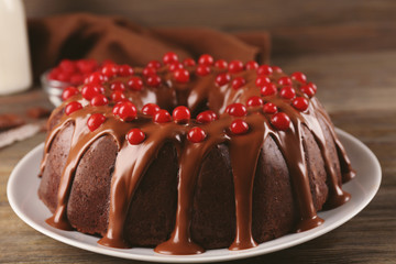 Chocolate cake with snowball tree berries on a table