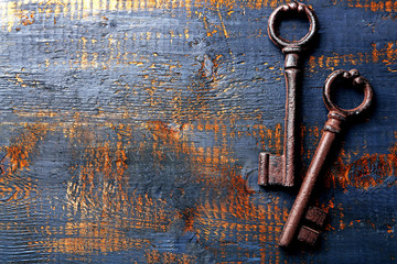 Old keys on blue scratched wooden background, copy space