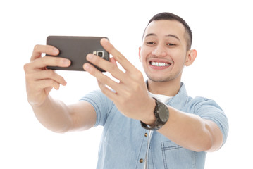 attractive casual man taking selfie photo using mobilephones cam