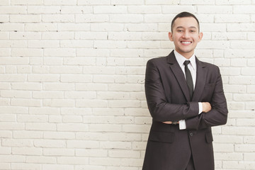 happy smiling businessman with crossed arms pose