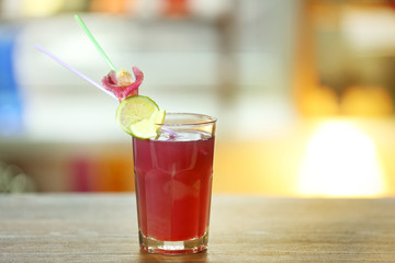 Glass of cocktail on bar background