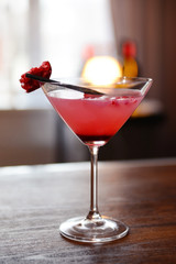 Glass of cocktail on bar background