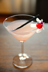 Glass of cocktail on bar background