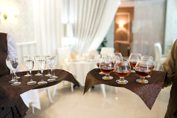 waiter with a tray welcomes visitors